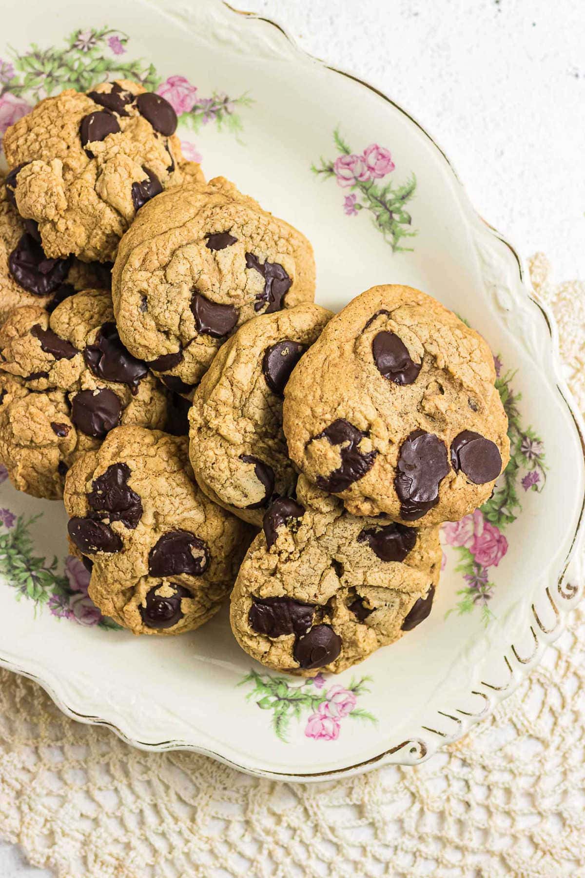 Gluten-free brown butter chocolate chip cookies served on a vintage floral plate