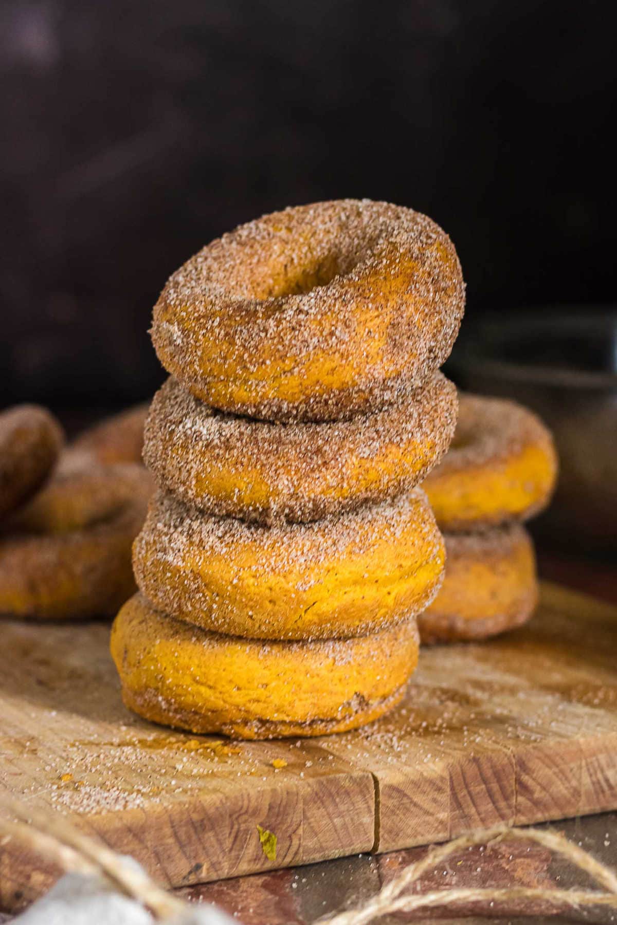 Stack of easy baked pumpkin donuts coated with cinnamon sugar