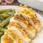 A closeup of a sliced chicken breast covered in Ritz crackers with title text overlay for Pinterest.