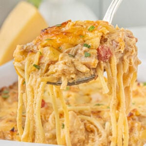 Cheesy BBQ chicken spaghetti casserole lifted from the baking dish with strands of creamy spaghetti and shredded chicken