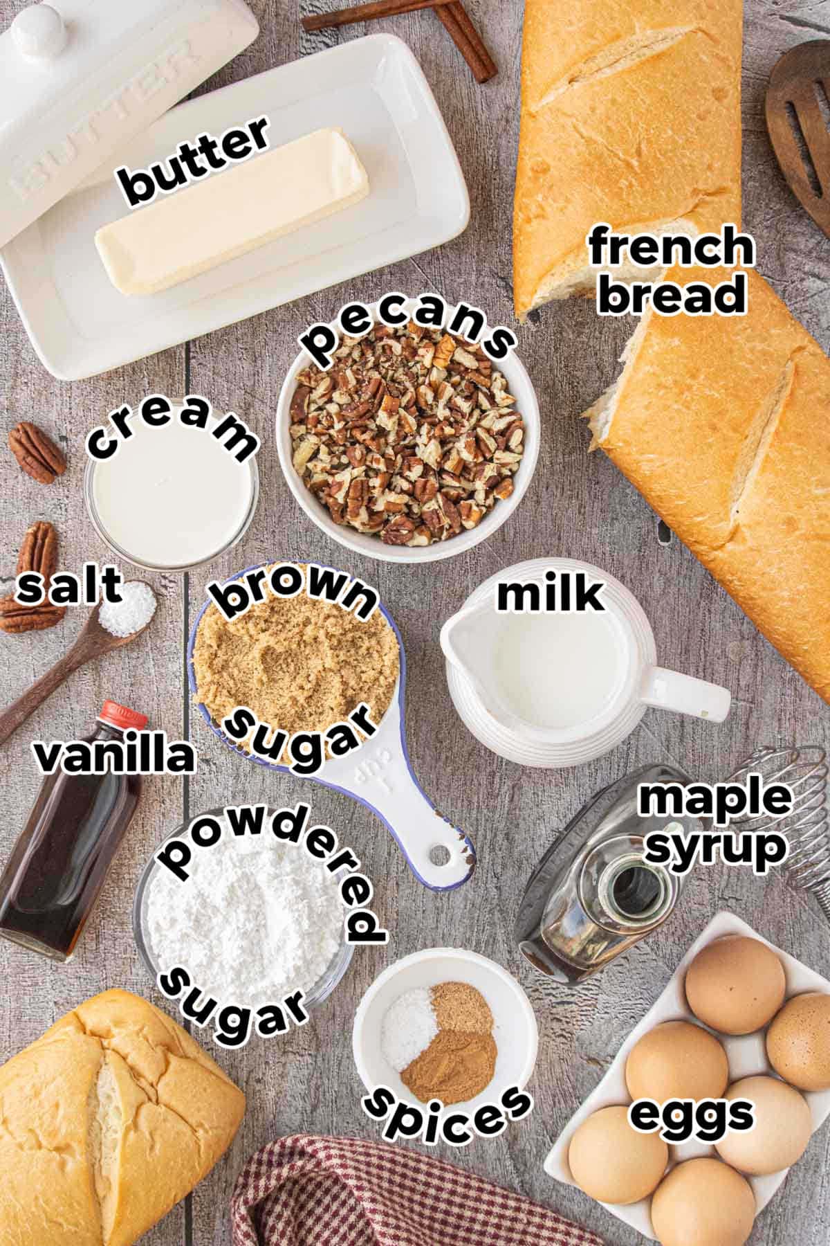 Ingredients for Brown Butter Praline French Toast Casserole including French bread, pecans, butter, cream, milk, eggs, brown sugar, maple syrup, vanilla, and spices.
