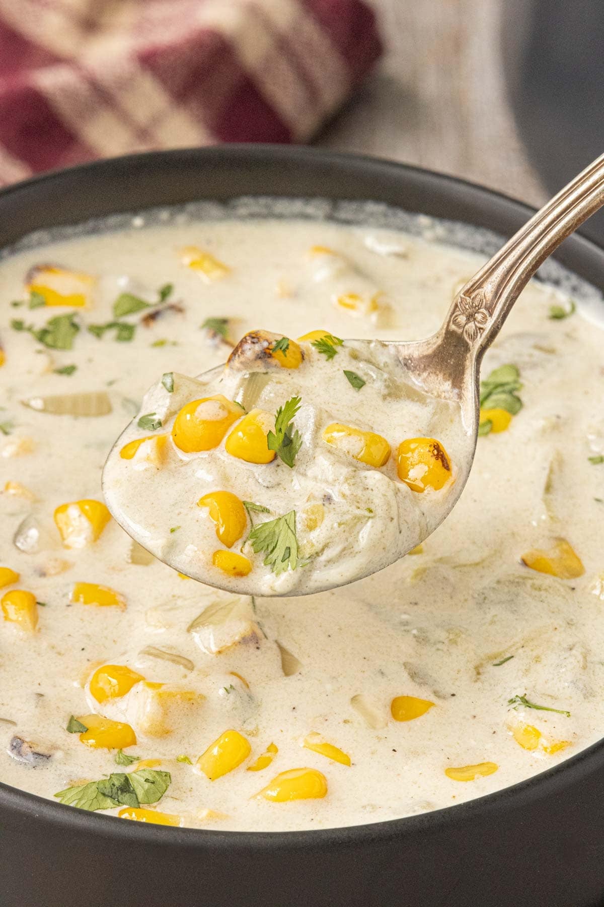 Close-up of Hatch chile corn chowder with roasted corn, green chiles, onion, and cilantro