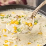 Spoonful of creamy Hatch chile corn chowder with roasted corn and chopped cilantro