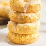 Stack of glazed baked sour cream donuts with text reading “Just 3 ingredients” and “Baked Sour Cream Donuts.”