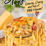 BBQ chicken spaghetti casserole with creamy sauce, shredded chicken, Rotel tomatoes, and melted cheese lifted from a baking dish.