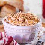 A closeup of a crock of cinnamon honey butter with text overlay for Pinterest.
