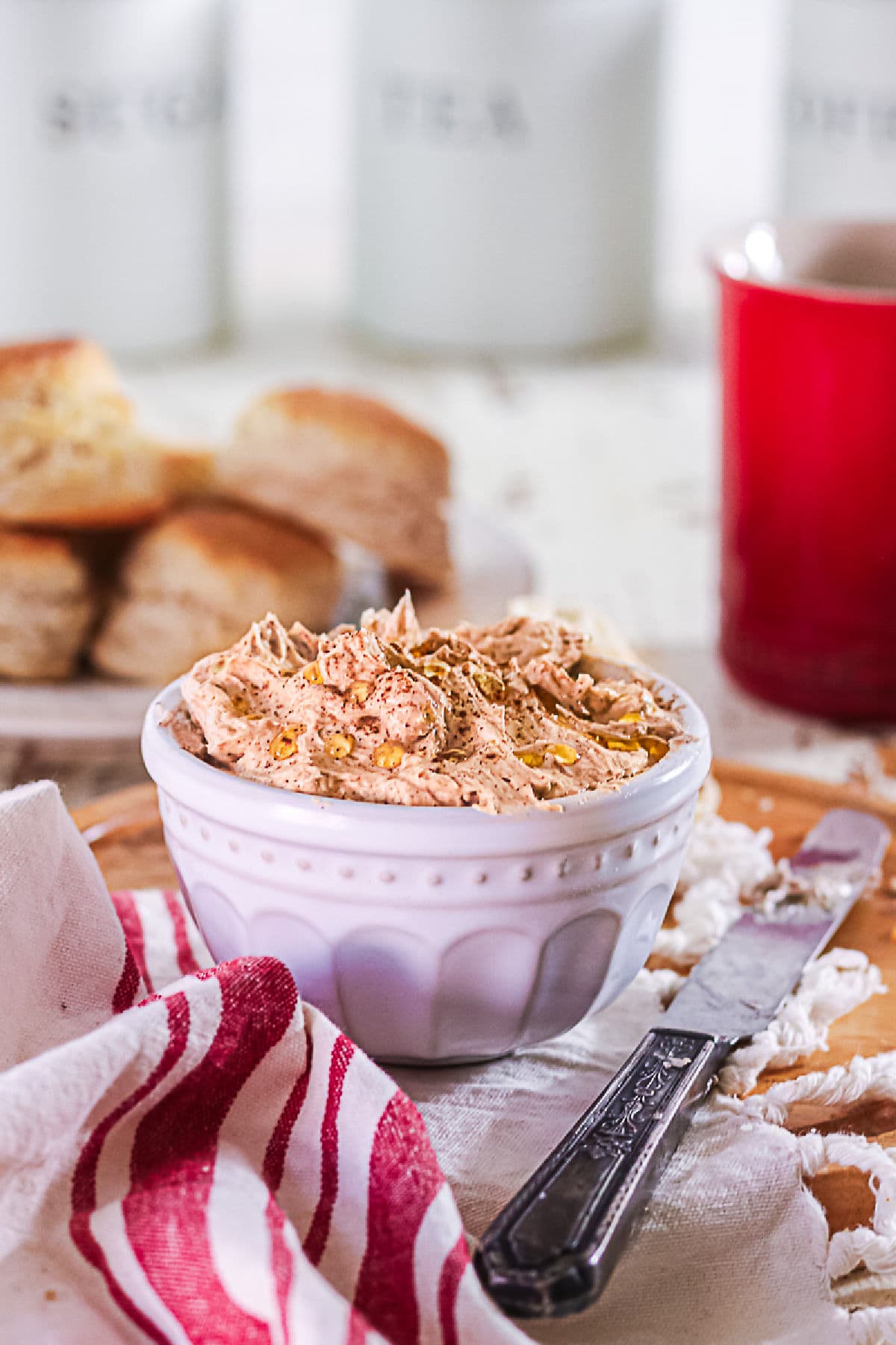 A closeup of homemade cinnamon honey butter in a white crock.