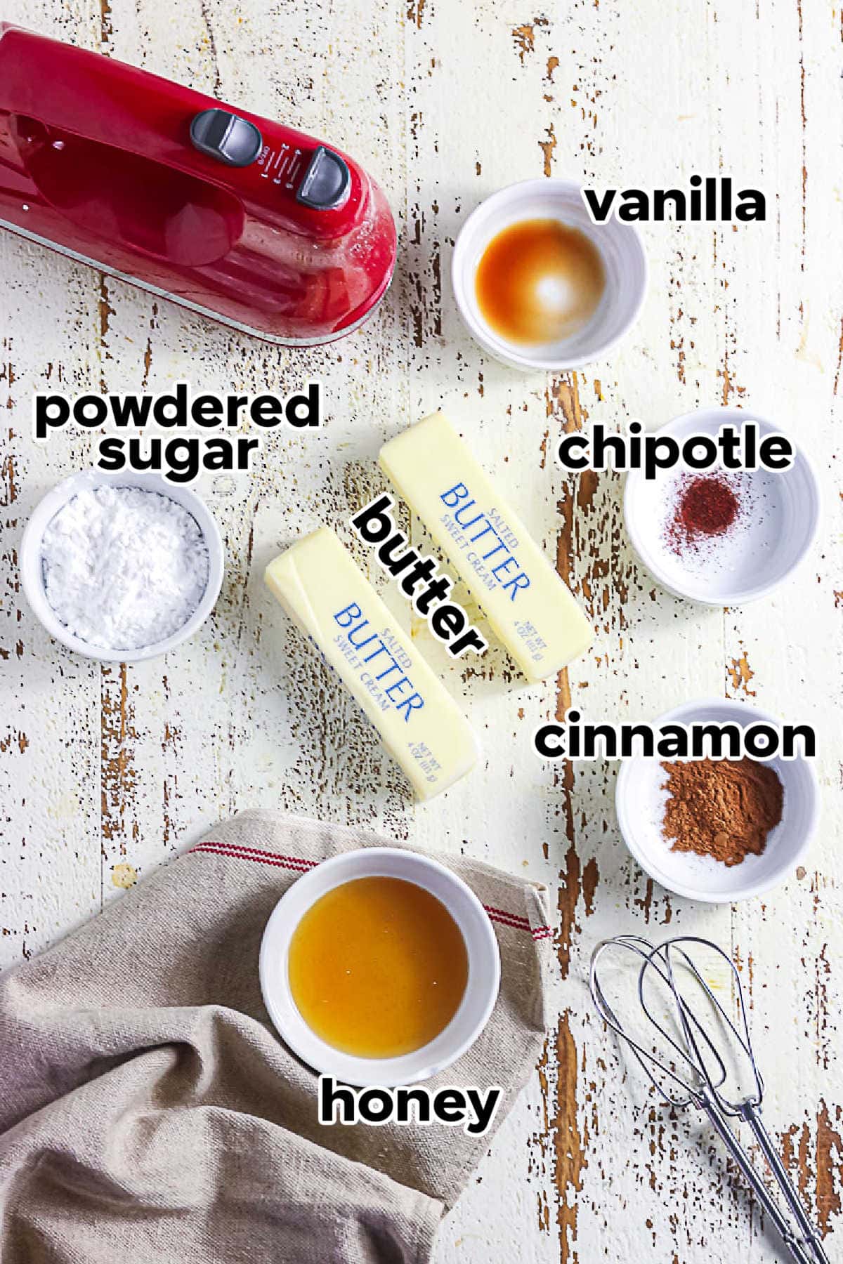 Ingredients for cinnamon honey butter including butter, honey, powdered sugar, cinnamon, vanilla, and chipotle