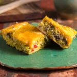 Two servings of crescent roll breakfast casserole on a green plate.