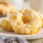 Glazed sour cream baked donuts arranged on a white plate with a soft, cake-like texture.
