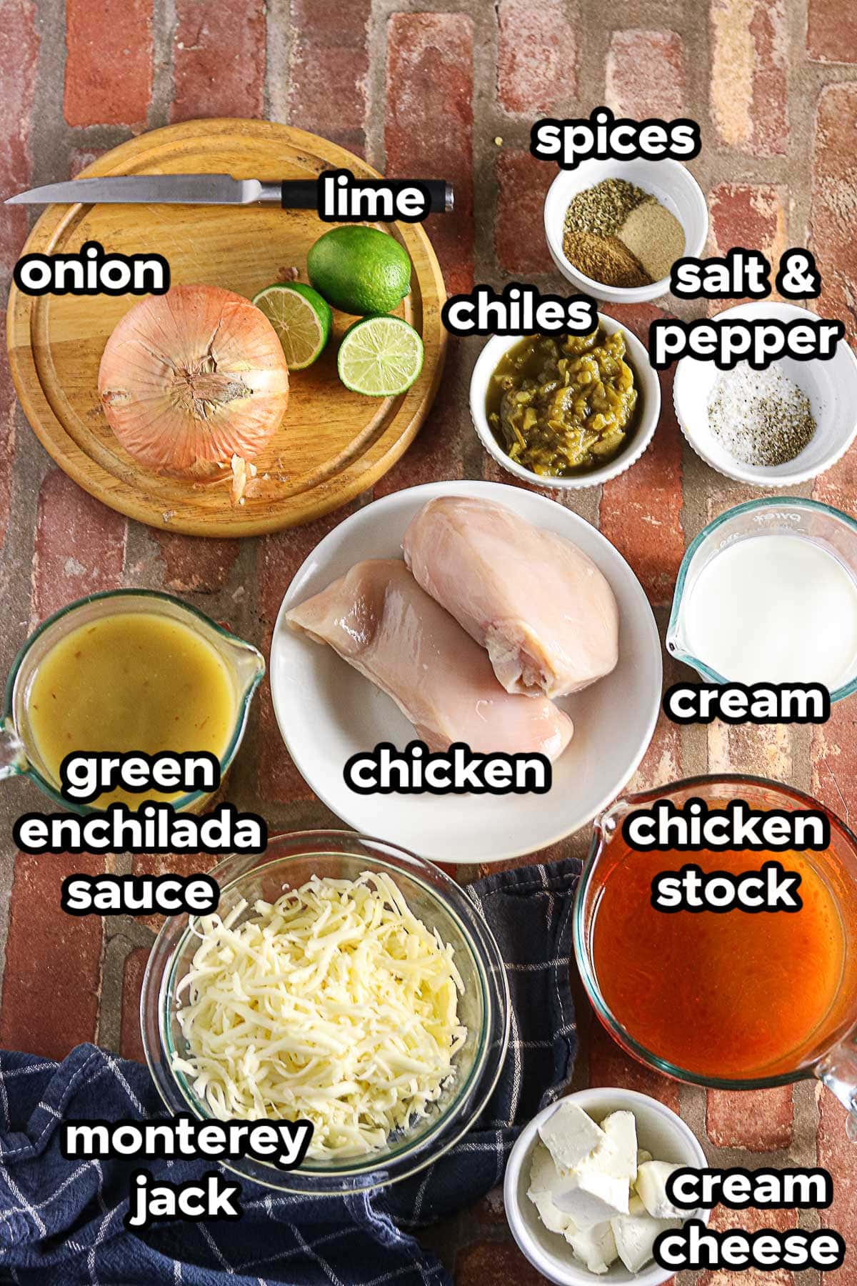 Ingredients for green enchilada chicken soup including chicken, green enchilada sauce, green chiles, cream cheese, Monterey Jack, and lime