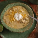 Green chicken enchilada soup topped with Monterey Jack cheese and sour cream.