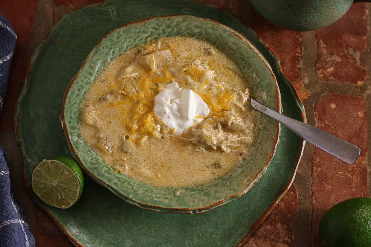 Green chicken enchilada soup topped with Monterey Jack cheese and sour cream.