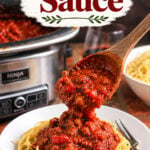 Slow cooker spaghetti sauce being spooned over spaghetti with text reading Slow Cooker Spaghetti Sauce