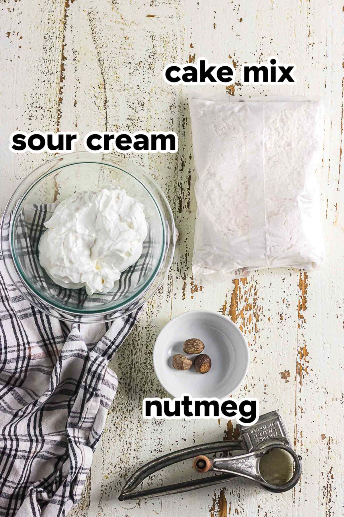 Ingredients for sour cream baked donuts including cake mix, sour cream, and nutmeg.