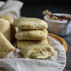 Stack of homemade Texas Roadhouse rolls with one torn open to show the soft, fluffy crumb