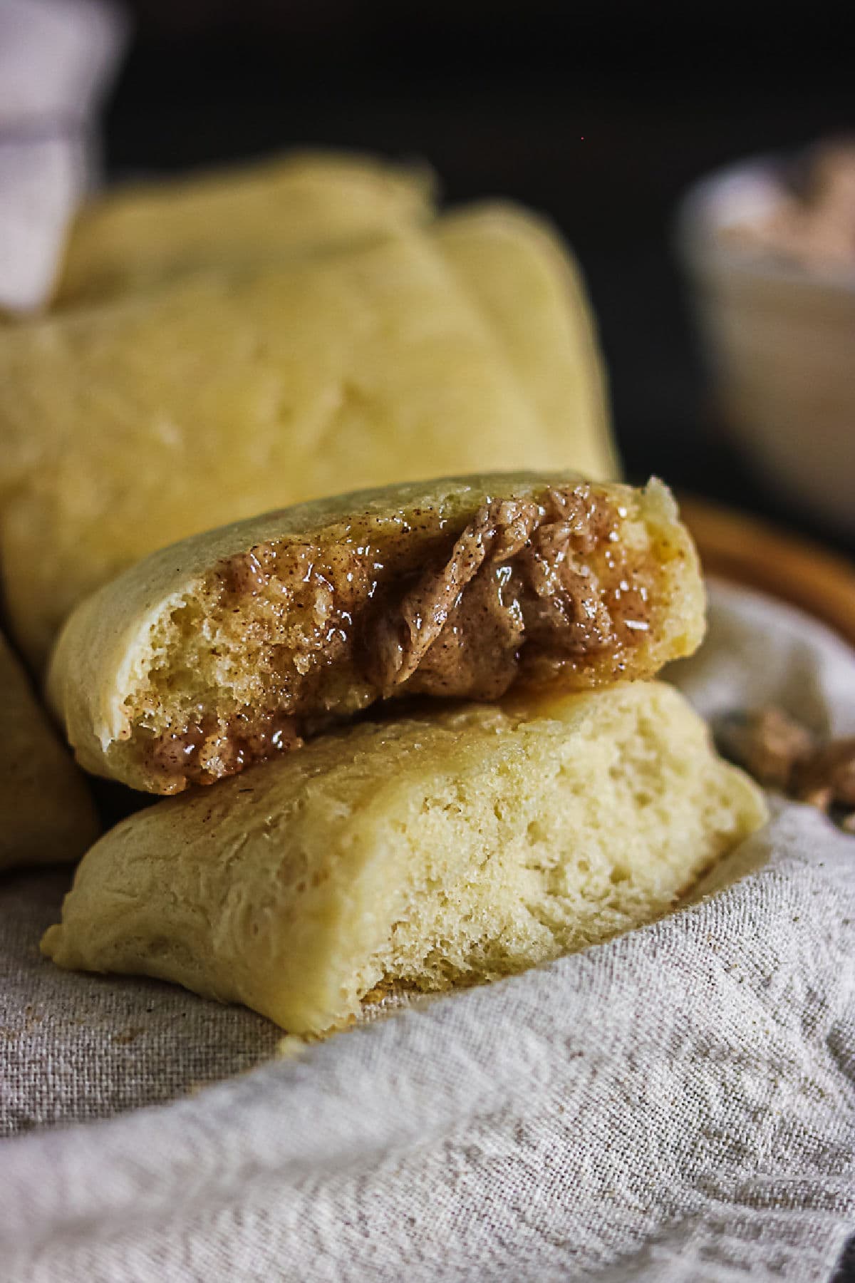 Warm Texas Roadhouse roll split open and spread with cinnamon honey butter