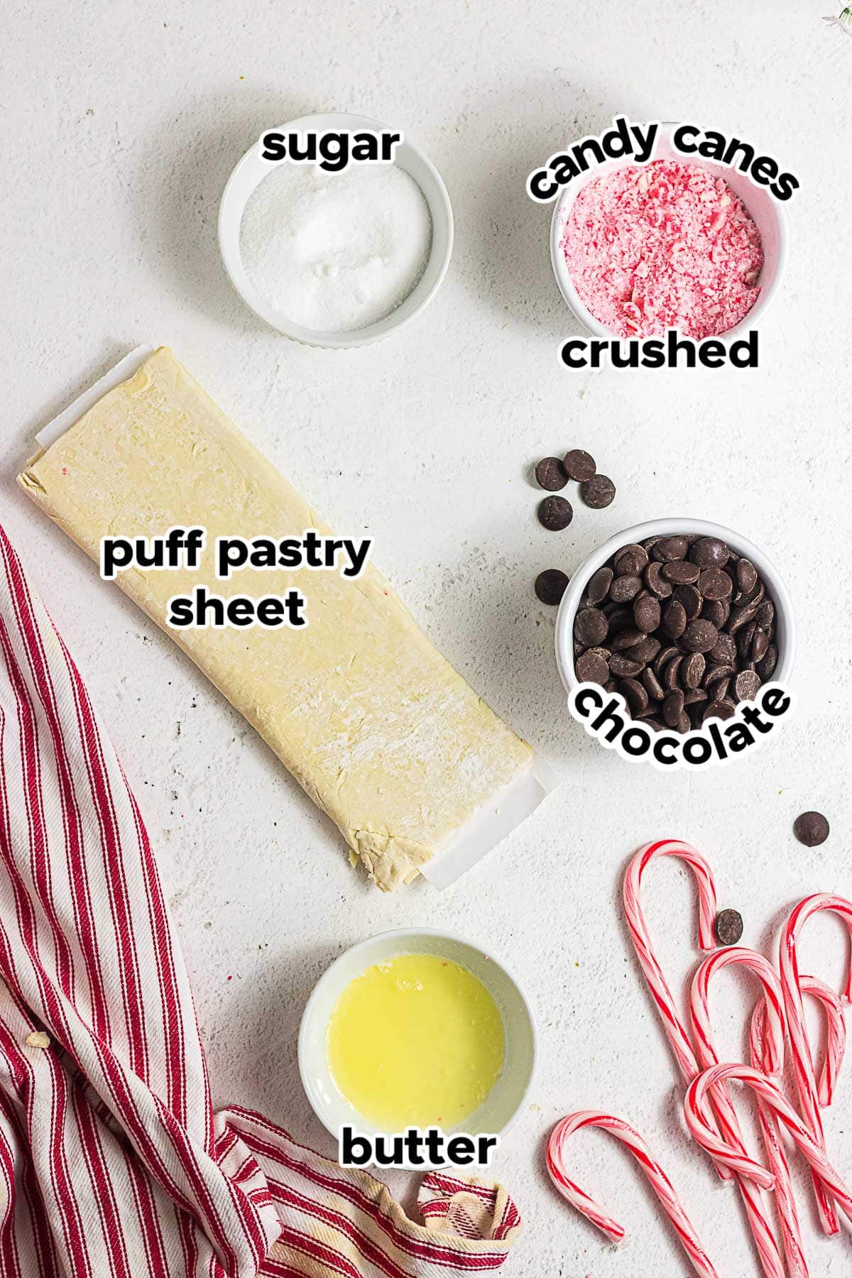 Ingredients for chocolate peppermint puff pastry cookies including puff pastry, butter, sugar, bittersweet chocolate, and crushed candy canes.