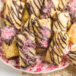 Flaky puff pastry cookies topped with bittersweet chocolate drizzle and crushed peppermint candy.