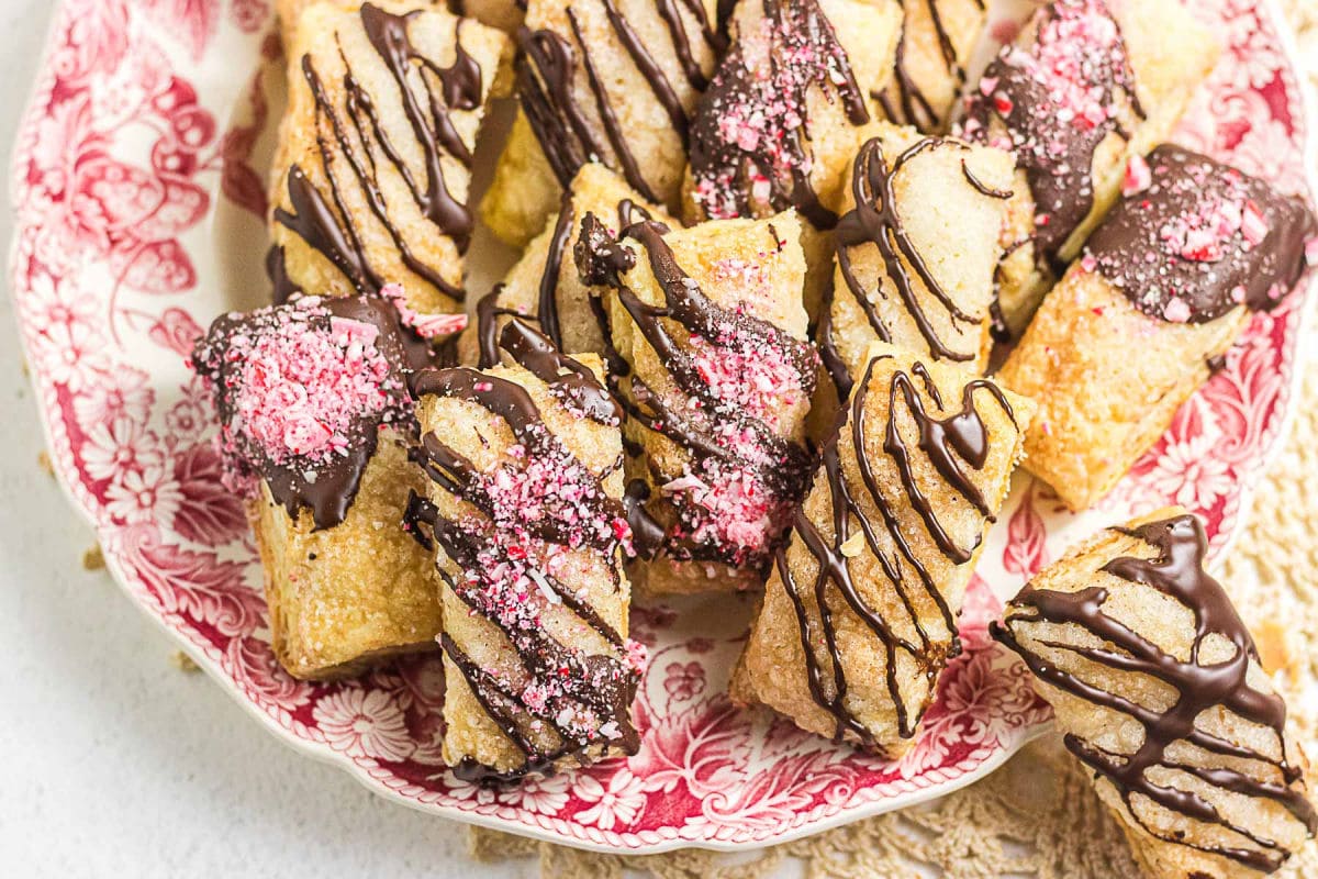 Flaky puff pastry cookies topped with bittersweet chocolate drizzle and crushed peppermint candy.