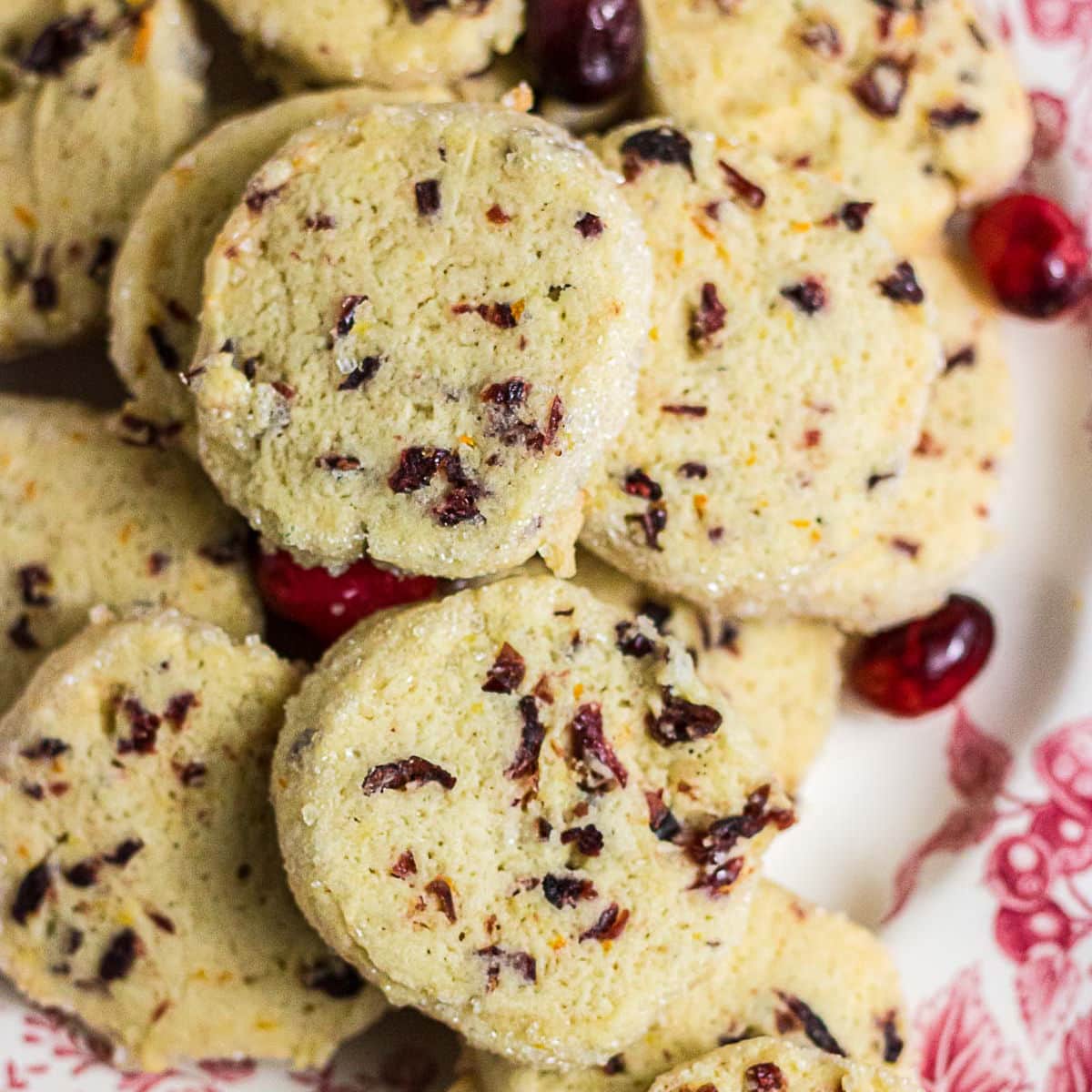 Close-up of sliced cranberry orange cookies filled with chopped dried cranberries and flecks of fresh orange zest.