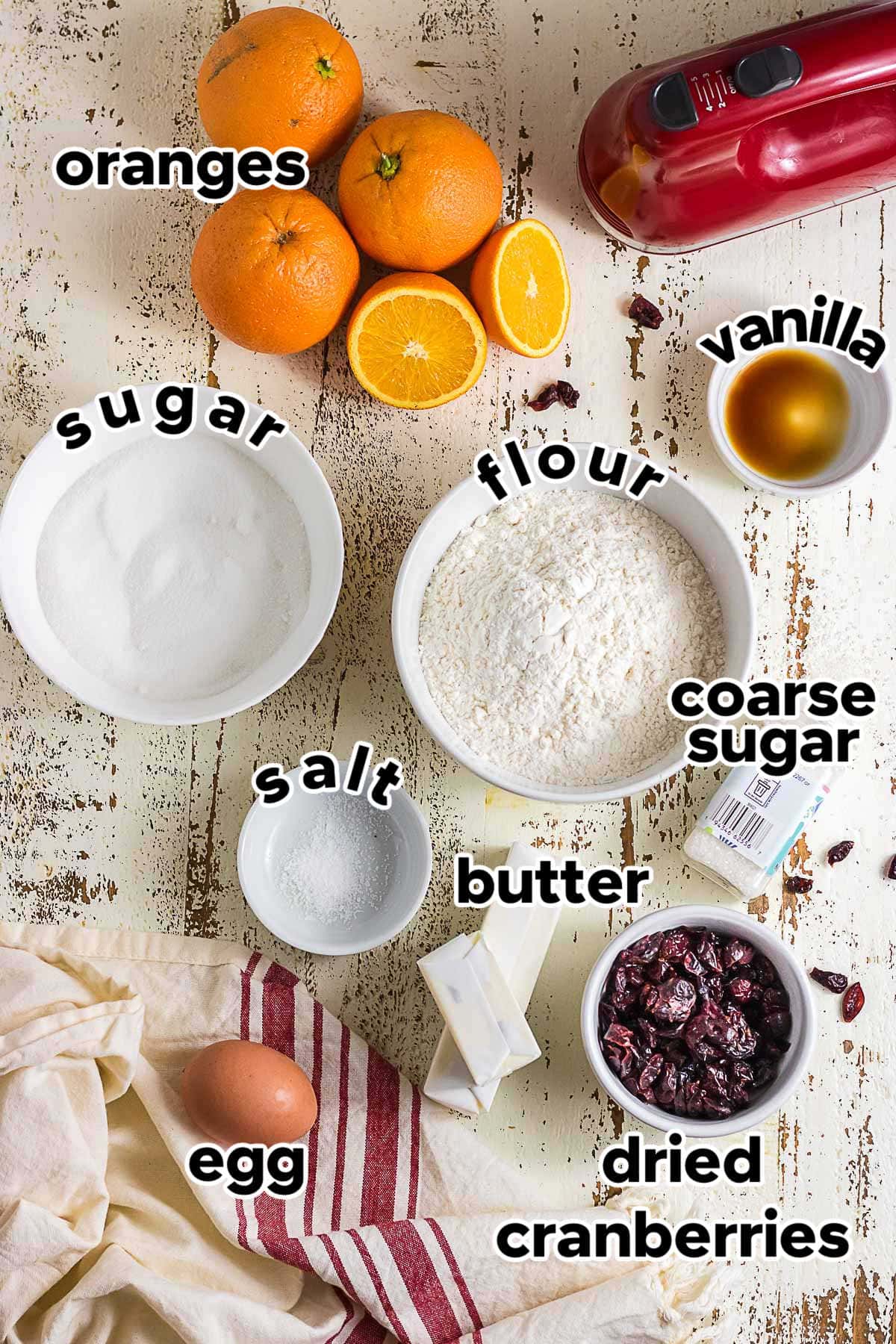 Ingredients for cranberry orange icebox cookies including butter, flour, sugar, egg, dried cranberries, fresh oranges, vanilla, and salt.