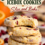 Stack of buttery cranberry orange icebox cookies with sparkling sugar edges and a bitten cookie on top, beneath a vintage Christmas-style recipe title.