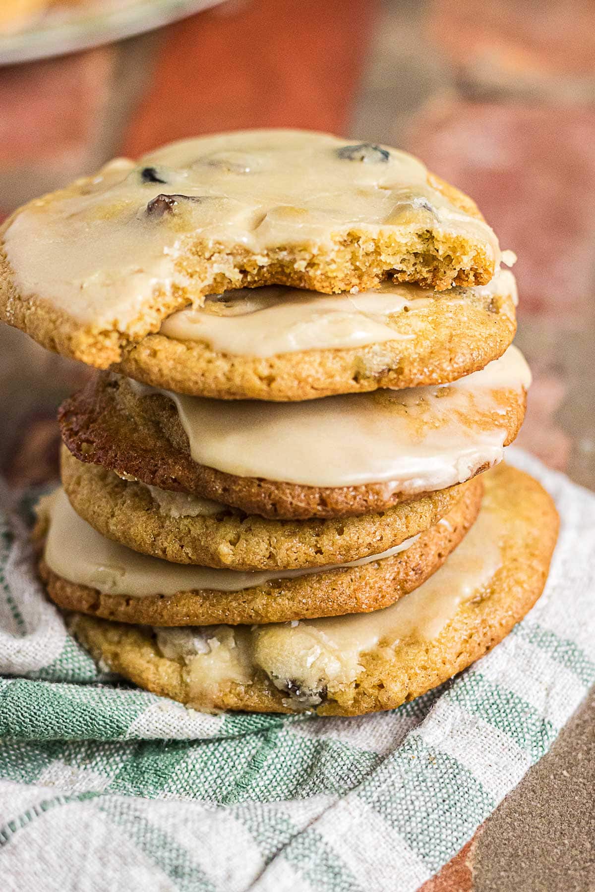 Stack of old-fashioned mincemeat cookies topped with coffee glaze, with a bite taken out of the top cookie.