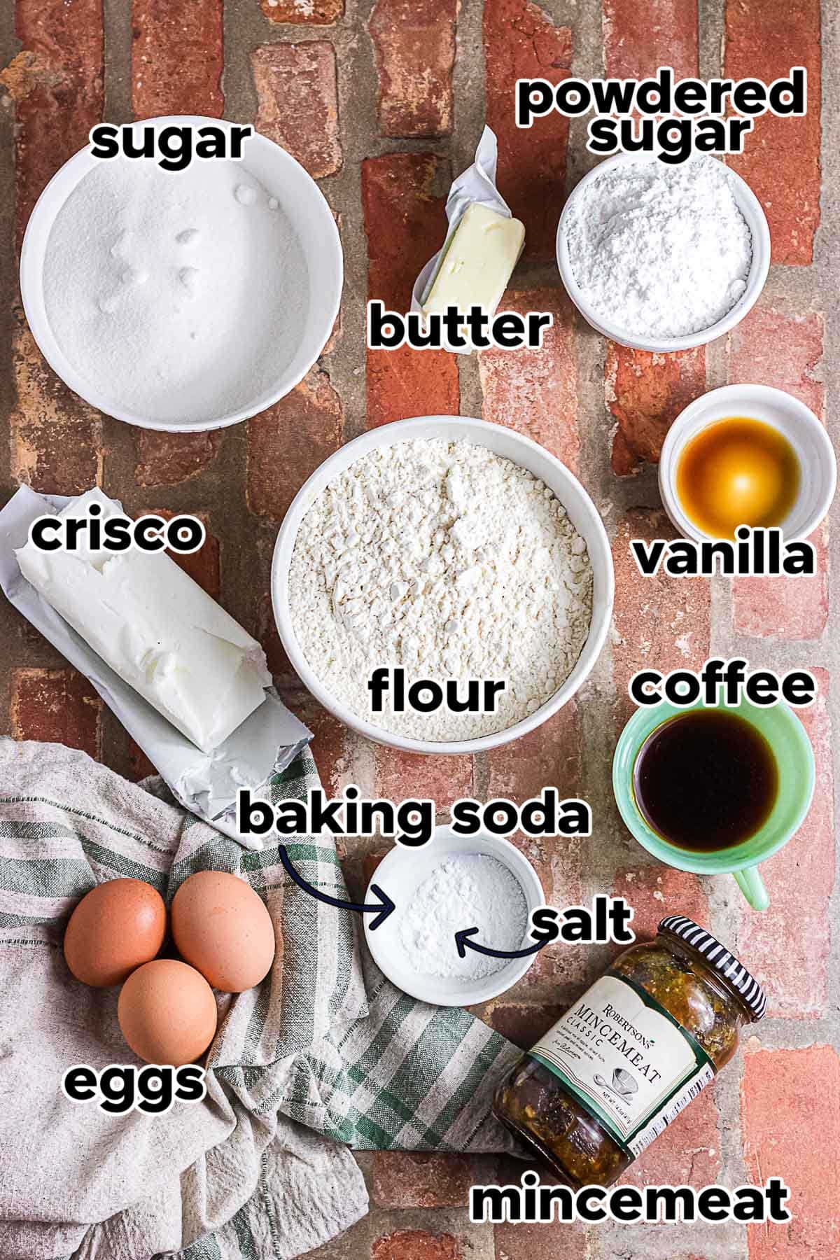 Ingredients for mincemeat cookies including flour, sugar, butter, shortening, eggs, prepared mincemeat, coffee, and powdered sugar.