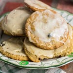 Close-up of homemade mincemeat cookies with creamy coffee icing on a vintage serving plate.
