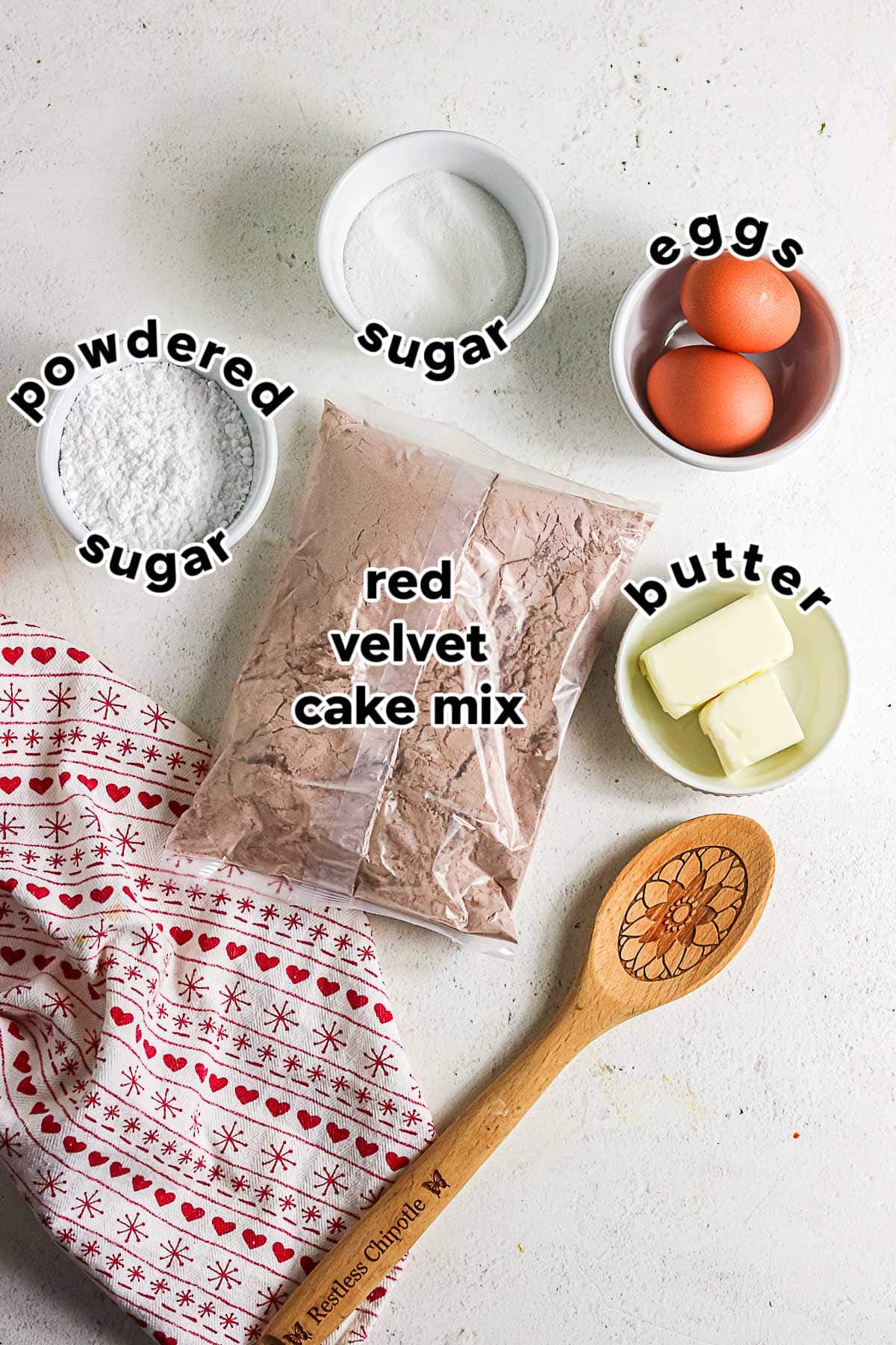 Ingredients for red velvet crinkle cookies with cake mix, eggs, butter, and sugars